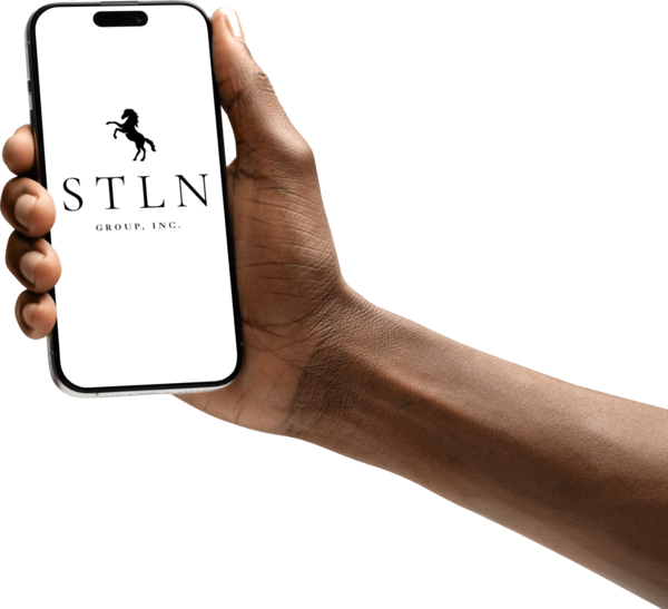 A hand holding a phone displaying the STLN Group, Inc. stallion logo