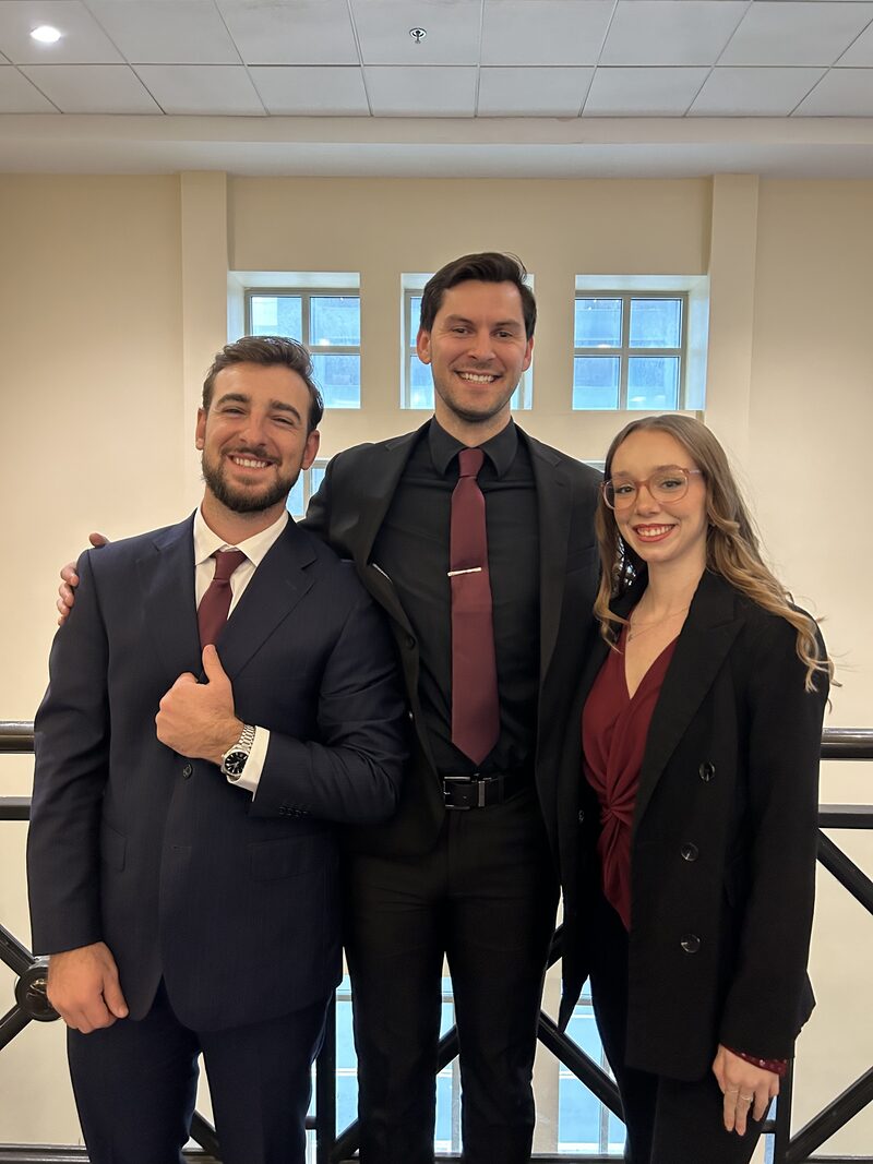 Three STLN Group team members smiling together